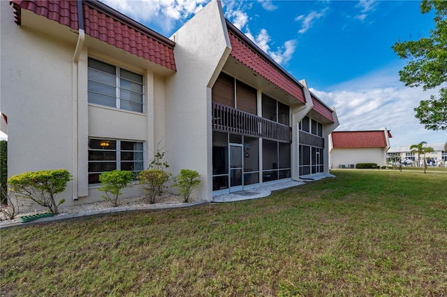 311 Garvin St Unit 301B, Punta Gorda, FL 33950 - rear view of property featuring stucco siding and a yard