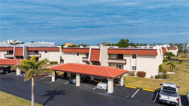 311 Garvin St Unit 301B, Punta Gorda, FL 33950 - view of building exterior with covered and uncovered parking and a residential view