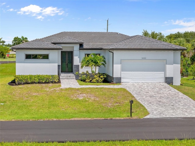 16322 Nogales Ct, Punta Gorda, FL 33955 - view of front facade featuring an attached garage, a front yard, and stucco siding