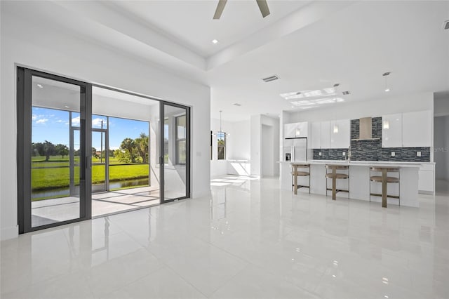 16322 Nogales Ct, Punta Gorda, FL 33955 - living room with light tile patterned floors, ceiling fan, and a water view