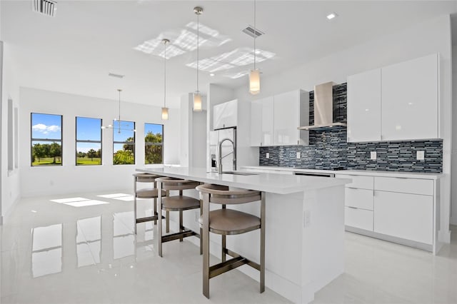16322 Nogales Ct, Punta Gorda, FL 33955 - kitchen with wall chimney range hood, modern cabinets, tasteful backsplash, and white cabinetry