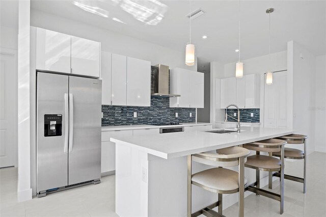 16322 Nogales Ct, Punta Gorda, FL 33955 - kitchen with stainless steel fridge with ice dispenser, wall chimney range hood, white cabinets, decorative backsplash, and light countertops