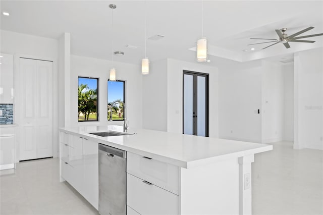 16322 Nogales Ct, Punta Gorda, FL 33955 - kitchen with dishwasher, modern cabinets, white cabinetry, light countertops, and a kitchen island with sink