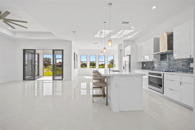 16322 Nogales Ct, Punta Gorda, FL 33955 - kitchen featuring wall chimney exhaust hood, stainless steel appliances, modern cabinets, light tile patterned floors, and white cabinets