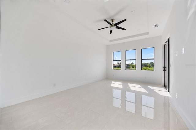 16322 Nogales Ct, Punta Gorda, FL 33955 - empty room with ceiling fan, a tray ceiling, and light tile patterned floors