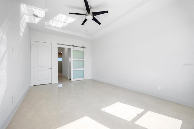 16322 Nogales Ct, Punta Gorda, FL 33955 - unfurnished bedroom featuring a barn door, light tile patterned floors, and ceiling fan