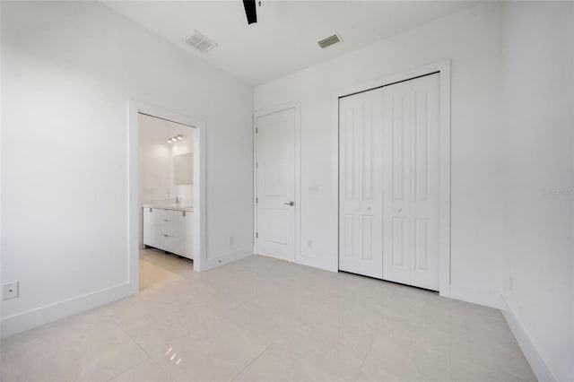 16322 Nogales Ct, Punta Gorda, FL 33955 - unfurnished bedroom featuring a closet, light tile patterned floors, ensuite bath, and a ceiling fan