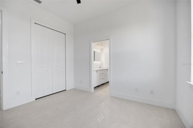 16322 Nogales Ct, Punta Gorda, FL 33955 - unfurnished bedroom with a closet, ensuite bathroom, and light tile patterned flooring