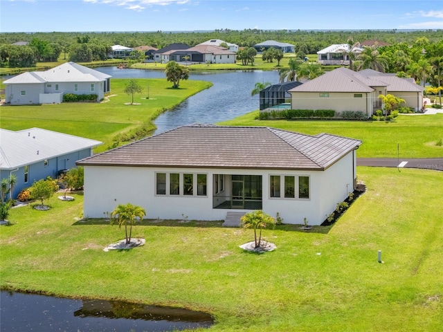 16322 Nogales Ct, Punta Gorda, FL 33955 - back of house with a water view, stucco siding, a yard, and a residential view