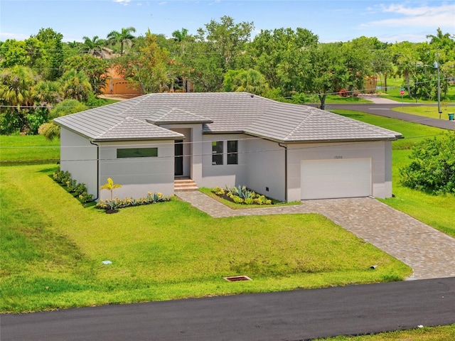 17200 Mint Ln, Punta Gorda, FL 33955 - view of front of property with decorative driveway, an attached garage, a front yard, and a tiled roof