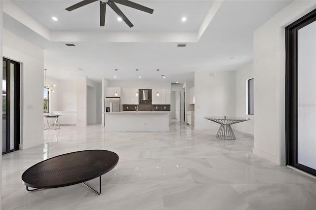 17200 Mint Ln, Punta Gorda, FL 33955 - living area with a tray ceiling, ceiling fan, recessed lighting, and light marble finish flooring