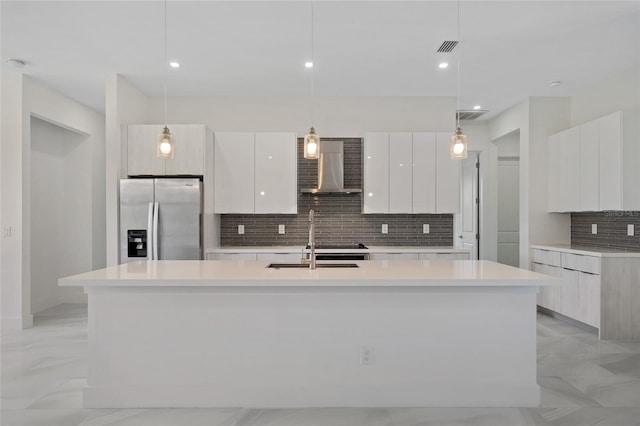 17200 Mint Ln, Punta Gorda, FL 33955 - kitchen with stainless steel refrigerator with ice dispenser, wall chimney range hood, modern cabinets, decorative backsplash, and recessed lighting