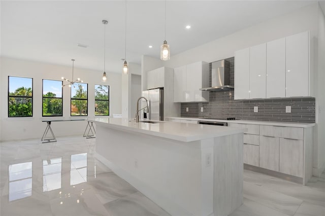 17200 Mint Ln, Punta Gorda, FL 33955 - kitchen with wall chimney exhaust hood, modern cabinets, light marble finish floors, stainless steel fridge with ice dispenser, and recessed lighting