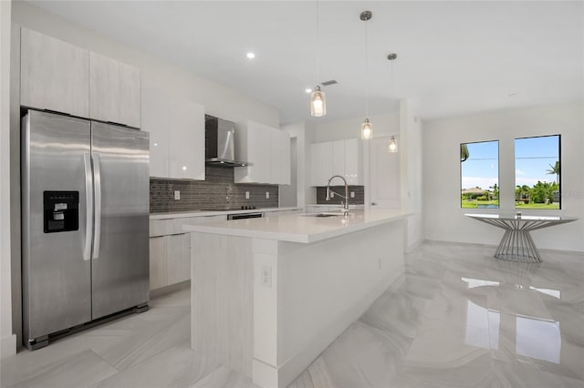 17200 Mint Ln, Punta Gorda, FL 33955 - kitchen featuring stainless steel refrigerator with ice dispenser, wall chimney range hood, modern cabinets, light marble finish floors, and recessed lighting