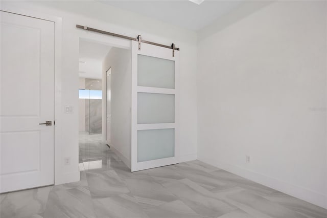 17200 Mint Ln, Punta Gorda, FL 33955 - empty room with a barn door and marble finish floors
