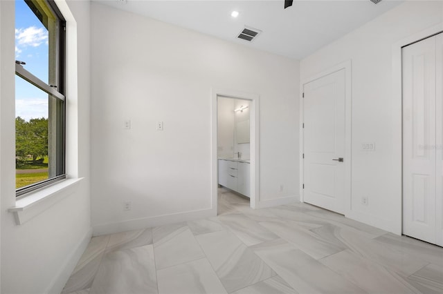 17200 Mint Ln, Punta Gorda, FL 33955 - unfurnished bedroom featuring baseboards and connected bathroom