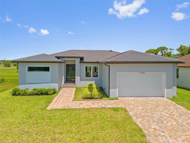 16506 Cape Horn Blvd, Punta Gorda, FL 33955 - prairie-style house with a garage, decorative driveway, a front yard, stucco siding, and french doors