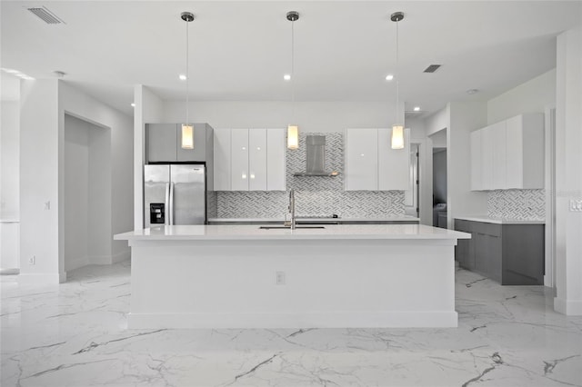 16506 Cape Horn Blvd, Punta Gorda, FL 33955 - kitchen with stainless steel refrigerator with ice dispenser, wall chimney exhaust hood, modern cabinets, light marble finish floors, and tasteful backsplash