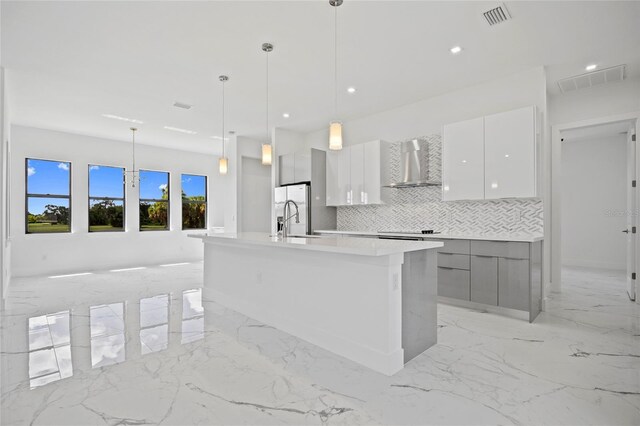 16506 Cape Horn Blvd, Punta Gorda, FL 33955 - kitchen featuring wall chimney range hood, modern cabinets, stainless steel refrigerator with ice dispenser, light marble finish floors, and backsplash