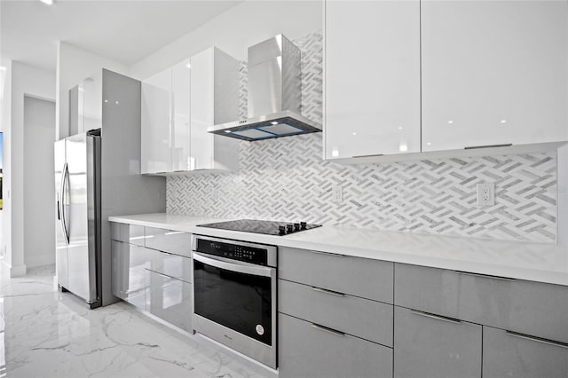16506 Cape Horn Blvd, Punta Gorda, FL 33955 - kitchen featuring wall chimney exhaust hood, stainless steel appliances, and modern cabinets