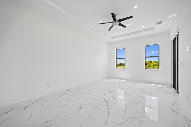 16506 Cape Horn Blvd, Punta Gorda, FL 33955 - spare room featuring recessed lighting, ceiling fan, light marble finish floors, and a tray ceiling