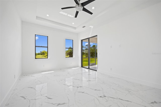 16506 Cape Horn Blvd, Punta Gorda, FL 33955 - unfurnished room with healthy amount of natural light, marble tiled floors, recessed lighting, a ceiling fan, and a raised ceiling