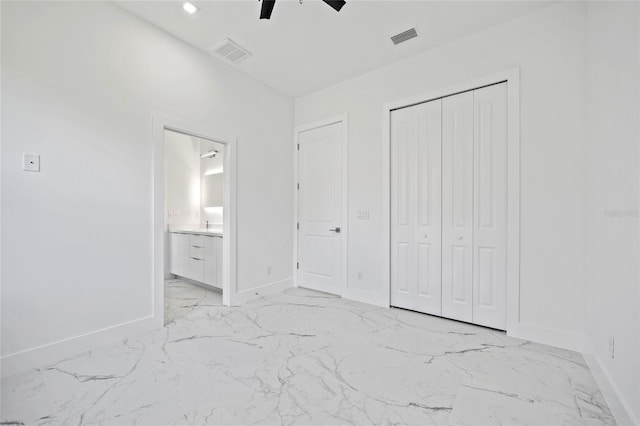 16506 Cape Horn Blvd, Punta Gorda, FL 33955 - unfurnished bedroom featuring light marble finish floors, a closet, ensuite bathroom, and a ceiling fan