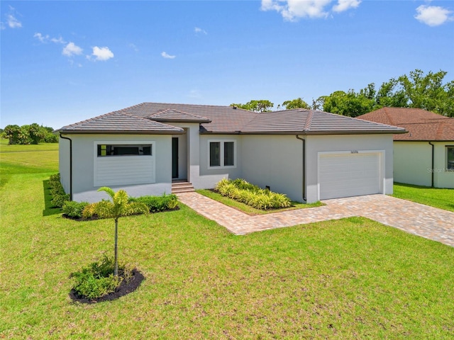 16506 Cape Horn Blvd, Punta Gorda, FL 33955 - view of front facade featuring an attached garage, stucco siding, a front lawn, and decorative driveway