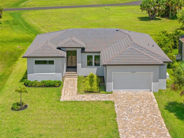 16506 Cape Horn Blvd, Punta Gorda, FL 33955 - view of front facade with french doors, stucco siding, a garage, and decorative driveway