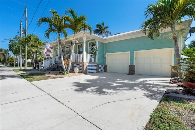 233 Durrance St, Punta Gorda, FL 33950 - view of front of house featuring a porch, driveway, an attached garage, and brick siding
