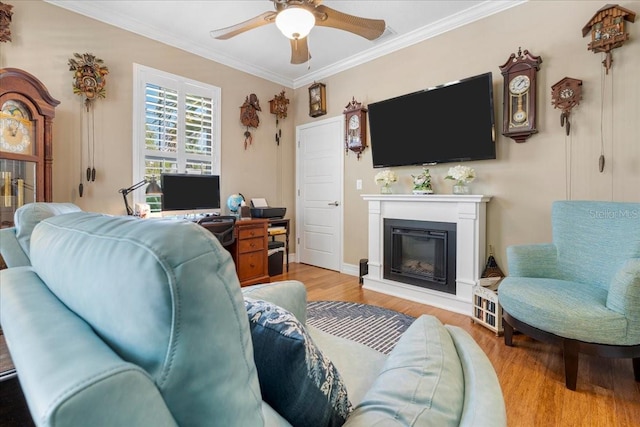 233 Durrance St, Punta Gorda, FL 33950 - living area with ornamental molding, ceiling fan, light wood-type flooring, and a glass covered fireplace