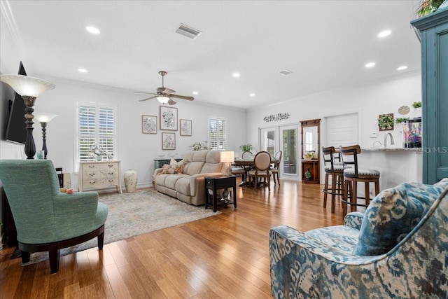 233 Durrance St, Punta Gorda, FL 33950 - living room with crown molding, light wood finished floors, a ceiling fan, and recessed lighting