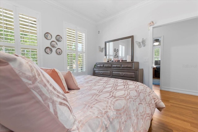 233 Durrance St, Punta Gorda, FL 33950 - bedroom with light wood finished floors, multiple windows, and crown molding
