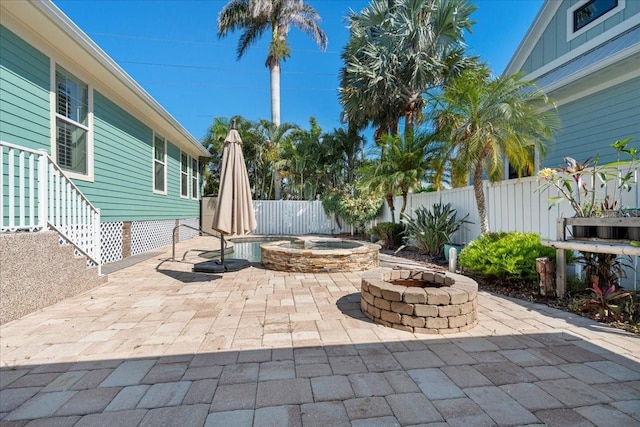 233 Durrance St, Punta Gorda, FL 33950 - fenced backyard featuring an outdoor fire pit, a patio area, and an in-ground hot tub
