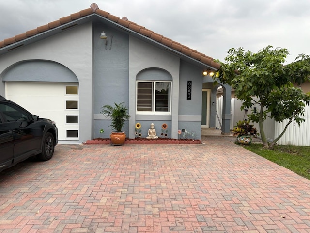 6853 W 25th Ct, Hialeah, FL 33016 - view of front of home with a garage, stucco siding, and a tile roof