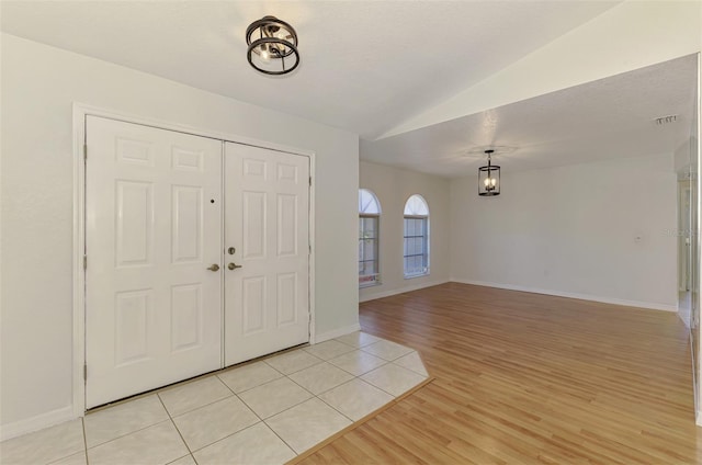 510 Border St, Port Charlotte, FL 33953 - foyer with vaulted ceiling and light wood-style flooring