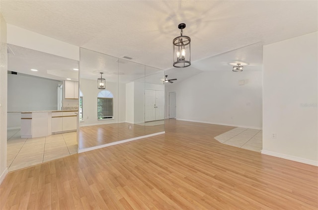 510 Border St, Port Charlotte, FL 33953 - unfurnished living room featuring light wood-style flooring and a chandelier