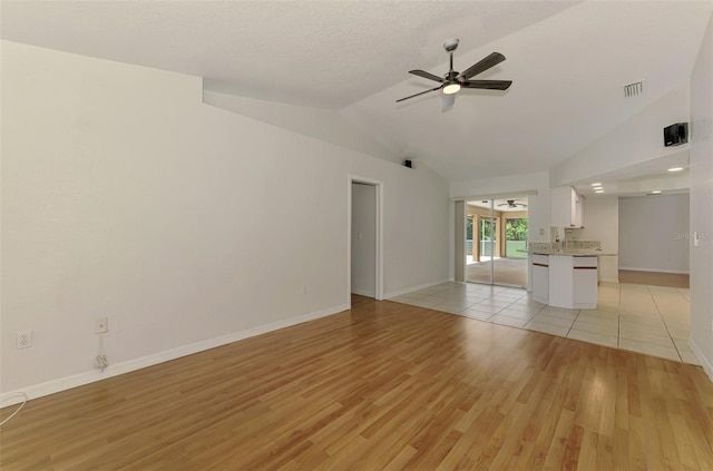 510 Border St, Port Charlotte, FL 33953 - unfurnished living room featuring lofted ceiling, ceiling fan, and light wood-type flooring