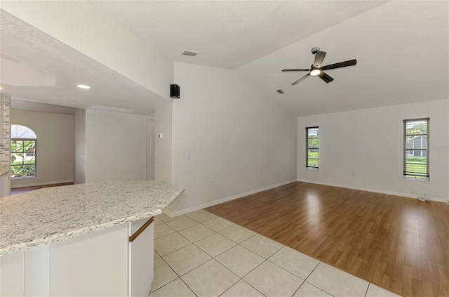 510 Border St, Port Charlotte, FL 33953 - unfurnished living room with light tile patterned flooring, ceiling fan, vaulted ceiling, and recessed lighting