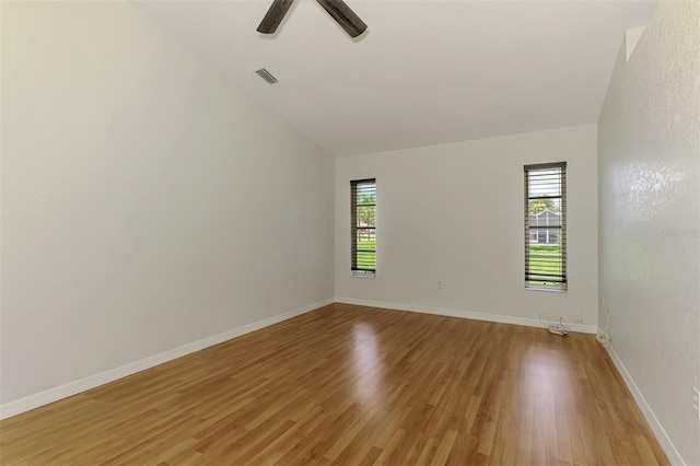 510 Border St, Port Charlotte, FL 33953 - empty room with light wood-style flooring, vaulted ceiling, and ceiling fan