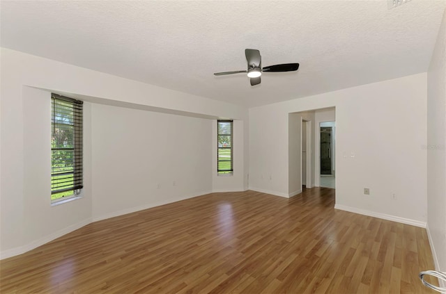 510 Border St, Port Charlotte, FL 33953 - unfurnished room with plenty of natural light, light wood-type flooring, a ceiling fan, and a textured ceiling