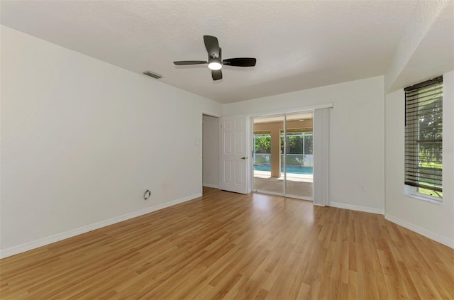 510 Border St, Port Charlotte, FL 33953 - spare room featuring light wood-type flooring, a ceiling fan, and a textured ceiling