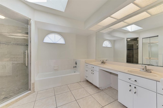 510 Border St, Port Charlotte, FL 33953 - bathroom with a skylight, double vanity, a bath, a shower stall, and tile patterned floors
