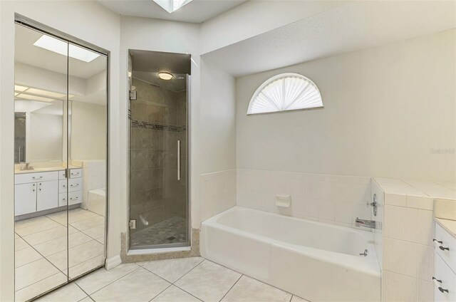 510 Border St, Port Charlotte, FL 33953 - full bathroom with vanity, tile patterned flooring, a garden tub, and a shower stall