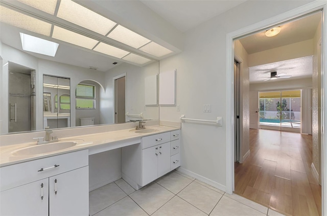 510 Border St, Port Charlotte, FL 33953 - full bathroom featuring double vanity, a skylight, and tile patterned floors