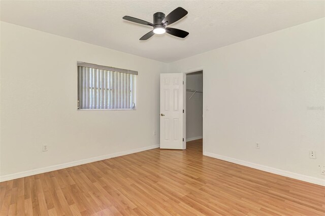 510 Border St, Port Charlotte, FL 33953 - unfurnished bedroom featuring light wood-type flooring, a spacious closet, ceiling fan, and a closet