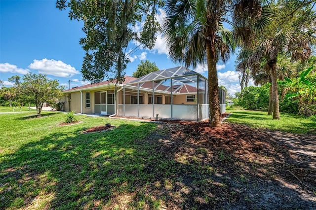 510 Border St, Port Charlotte, FL 33953 - rear view of house with a yard and glass enclosure