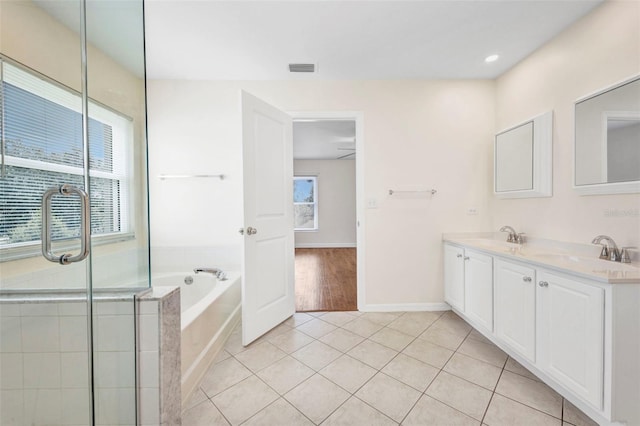 200 Valdiva St, Punta Gorda, FL 33983 - bathroom featuring a garden tub, double vanity, tile patterned floors, and a shower with shower door