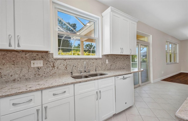 200 Valdiva St, Punta Gorda, FL 33983 - kitchen with dishwasher, backsplash, white cabinets, light stone counters, and light tile patterned flooring