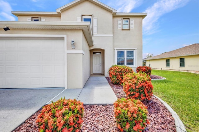 200 Valdiva St, Punta Gorda, FL 33983 - townhome / multi-family property featuring stucco siding, a front yard, and an attached garage